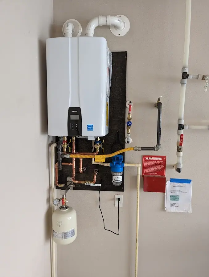 Professional plumber installing copper piping in a Bullard home